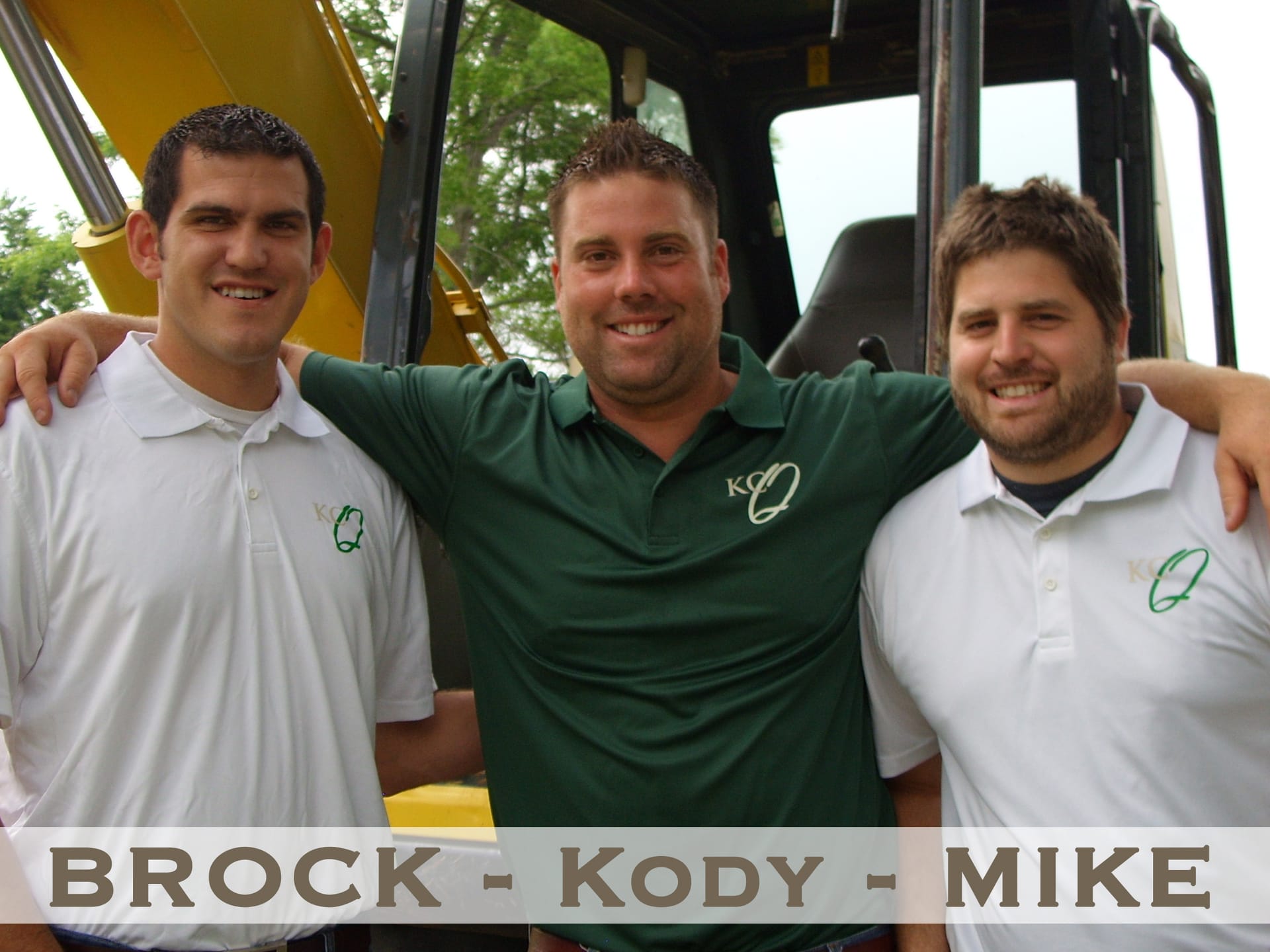 The KC Quality crew, Brock, Kody, and Mike, in front of an excavator